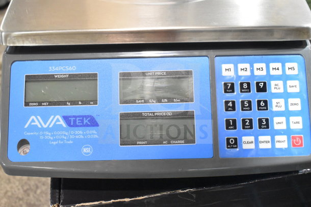 Brand new AvaTek 334PCS60 digital price computing scale, 60 lb. capacity, with surface scratches, electronic display, and keypad.