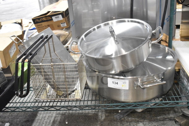Three new scratch-and-dent items: Henny Penny 50703 full-size autolift basket, two stock pots. Auction label "134, QTY 3".