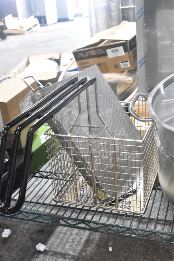 Brand new Henny Penny 50703 basket with auto-lift feature, alongside two scratch and dent stock pots on a wire shelf.
