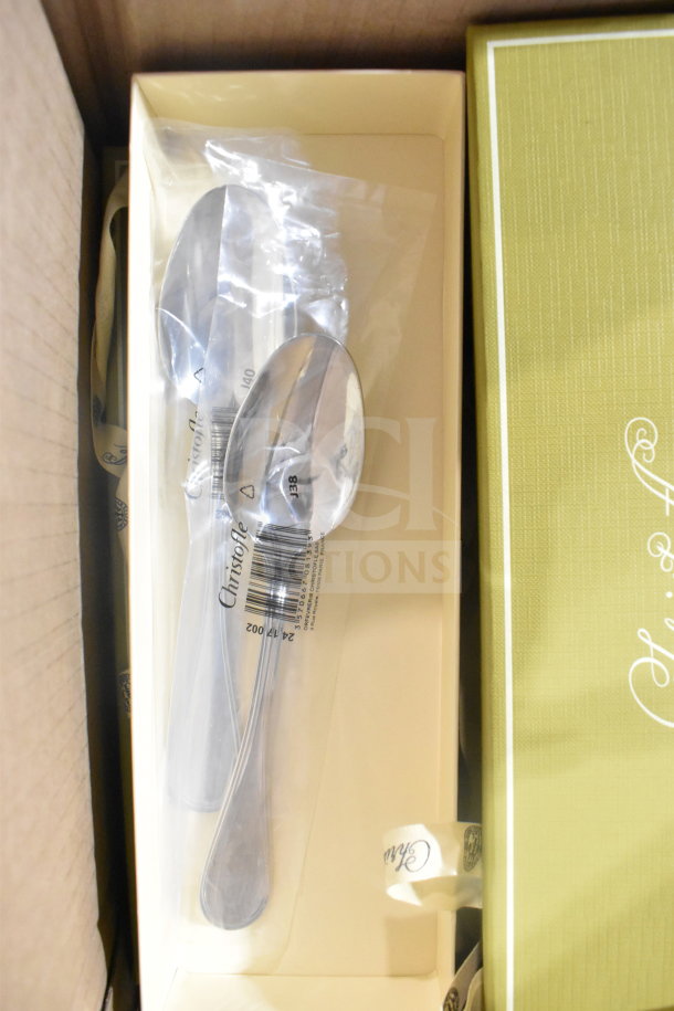 Brand new Christofle spoons in packaging in box, minor cosmetic dents, quality cutlery auction item, five pieces.