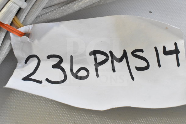 White tag reading "236PMS14" attached to coiled cables, indicating scratch and dent auction items.