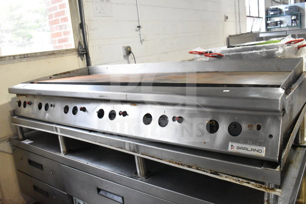 Garland commercial gas countertop griddle with flat top, stainless steel, multiple control knobs, used condition.