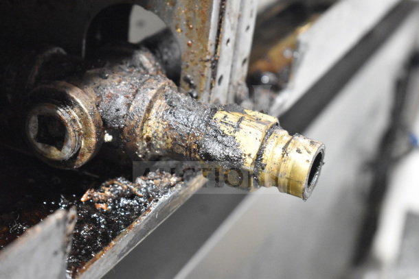 Close-up image of Garland Commercial Gas Griddle component, showing rust and grime on the metal connection part.