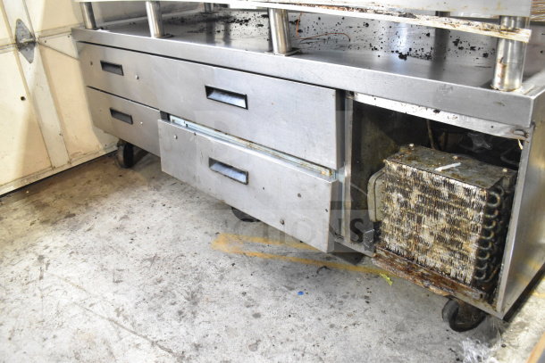 Delfield 4-drawer chef base on casters, commercial-grade. 115 volts, 1 phase. Some surface wear visible.