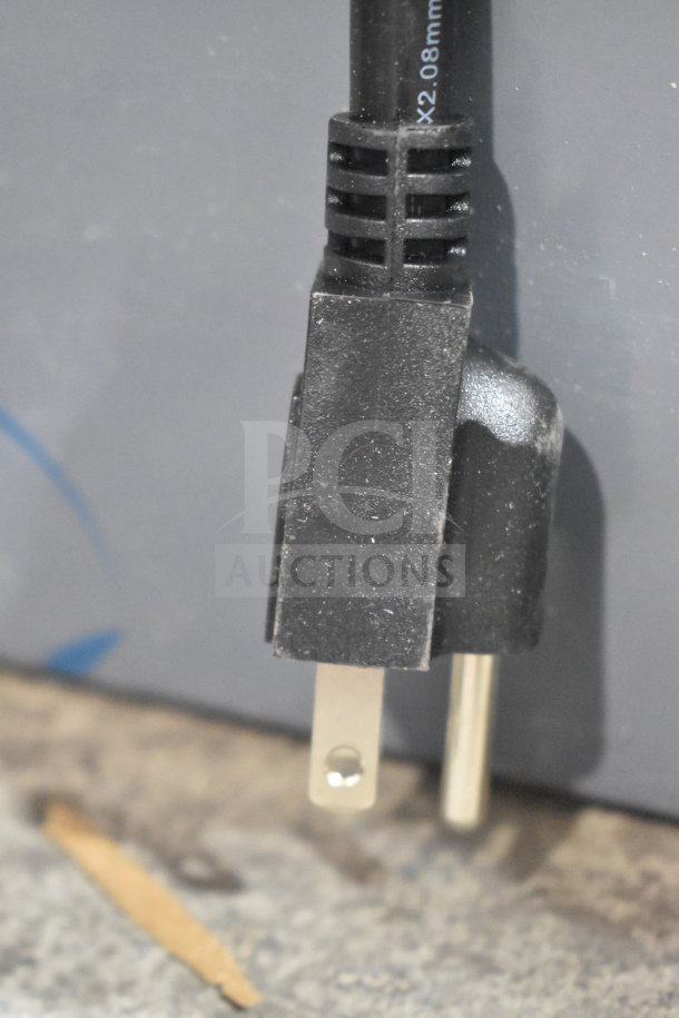Close-up of a two-prong plug connected to the Avantco 177DPO18S Single Deck Countertop Pizza/Bakery Oven.