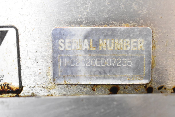 Serial number plate on Turbochef HhC2020 oven, marked "HHC2020ED07235." Surface shows signs of wear.
