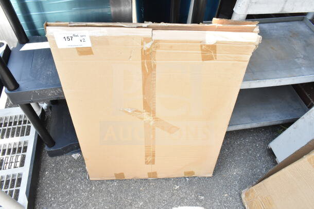 Cardboard package with "157" label indicating quantity x2, showing external wear, auction lot item.