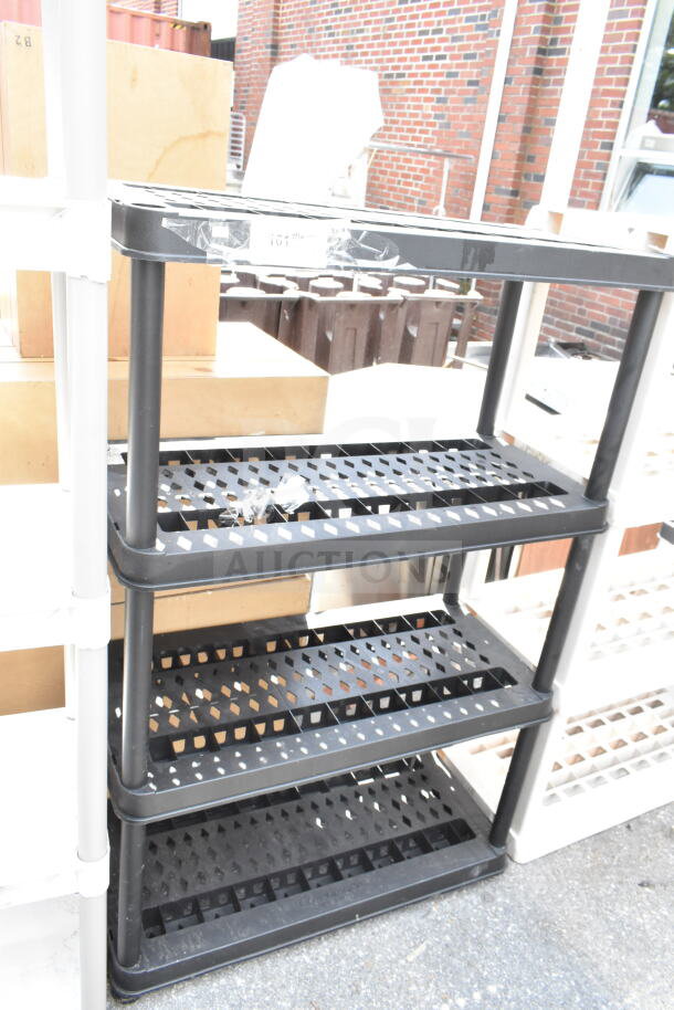 Black Poly 4 Tier Shelving Unit, durable plastic, open-grid shelves, good condition, ideal for storage, measures approx. 24x14x54 inches.