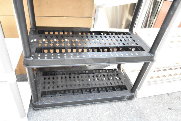 Black Poly 4 Tier Shelving Unit, perforated shelves, durable plastic, good condition, ideal for garage or storage use.
