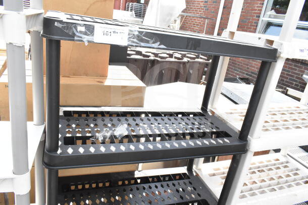 Black Poly 4 Tier Shelving Unit, used, lattice design, durable construction, ideal for storage, minor surface marks.