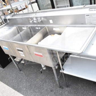 Duke Commercial 3 Bay Sink with dual drain boards, faucet, and handles; stainless steel, used condition, visible Subway markings.