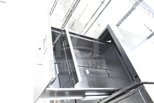 2 black four-drawer filing cabinets, pre-owned, with visible handles. No labels or markings shown.