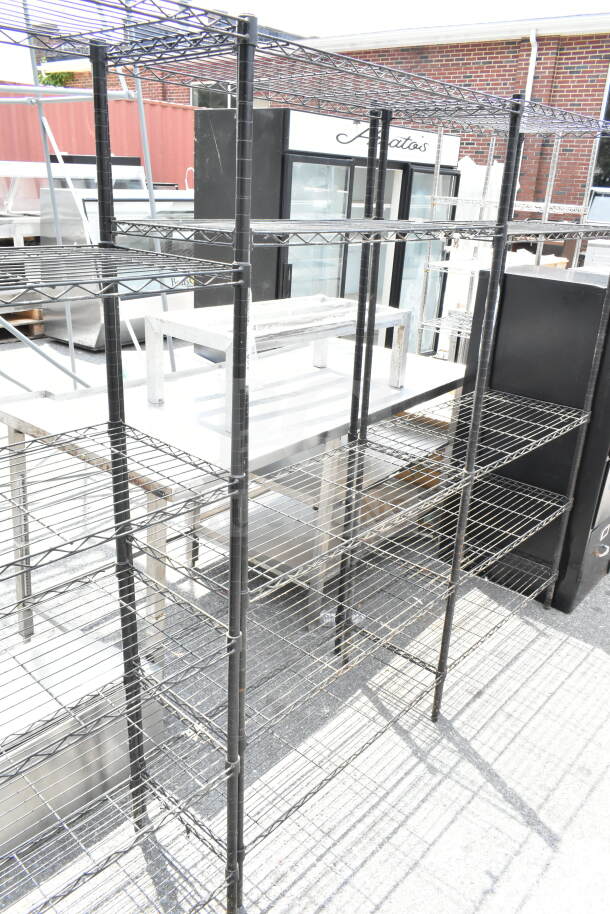 Black 5-tier wire shelving unit, sturdy metal construction, in good condition. Buyer must dismantle. Consider freight charges.