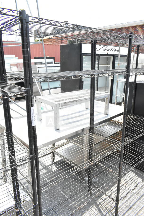 Black 5-tier wire shelving unit in good condition. Buyer must dismantle. Consider freight charges.
