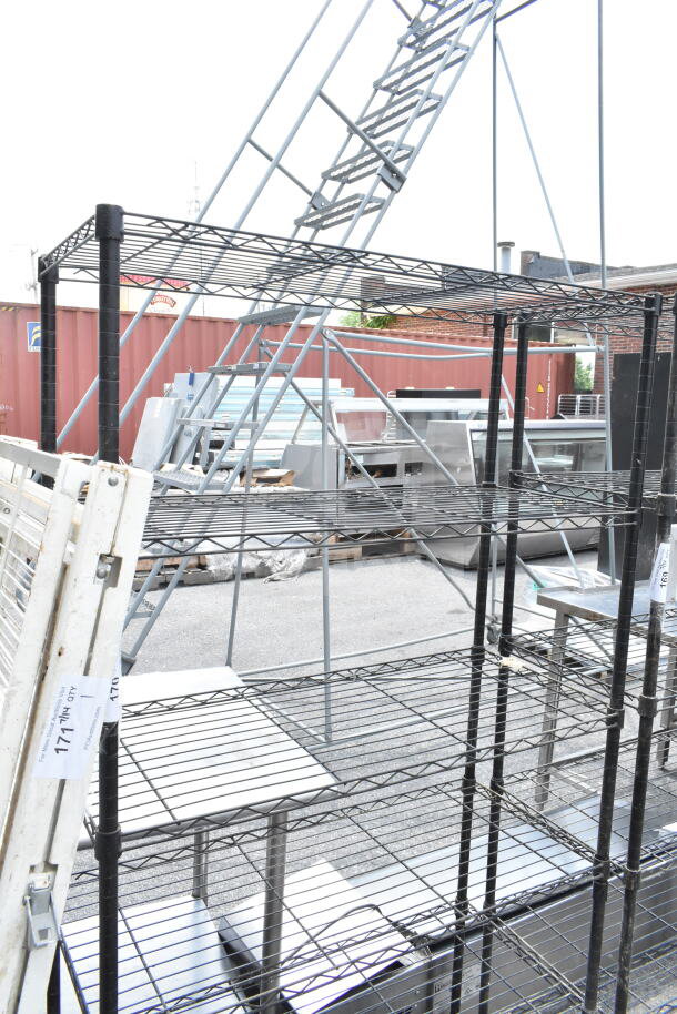 Black 6-tier wire shelving unit with metal frame. Requires dismantling by buyer. Ideal for storage. Consider freight costs.