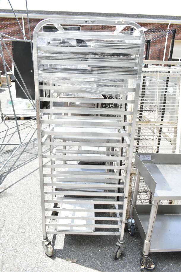 Commercial pan transport rack with multiple shelves on durable commercial casters, made of metal, in used condition.
