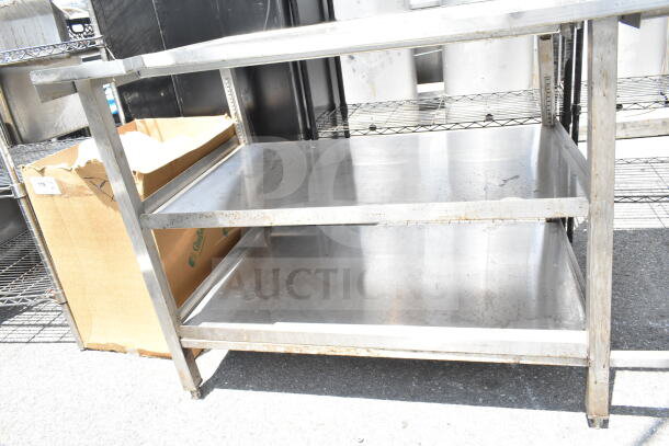 Commercial table with two under shelves, stainless steel, sturdy, good condition, ideal for kitchen or workspace.