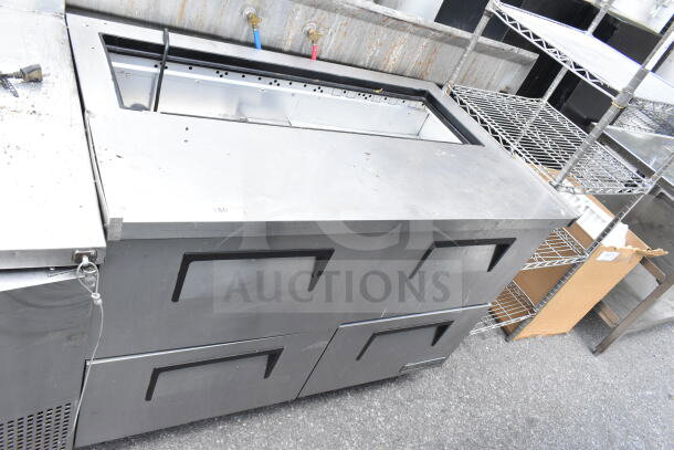 True commercial prep table with four drawers, missing top. Features 115 volts, 1 phase. Used condition.