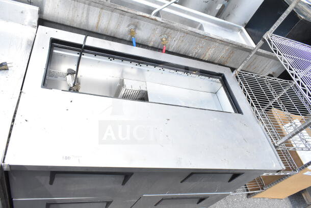 True commercial prep table with 4 drawers, missing top. Requires 115 volts, 1 phase. Stainless steel exterior.