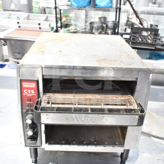 2021 Waring CTS1000B commercial conveyor toaster, 208V, showing visible wear, with control knobs and Waring branding.