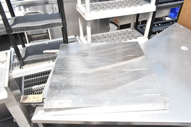 Metal panel with visible wear, silver finish, rectangular shape, features marking indicating lot number 184.