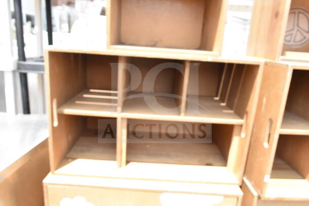 Two wooden cabinets with multiple compartments, used condition, visible scratches; ideal for storage or display.