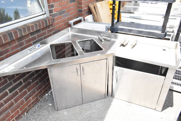Commercial stainless steel corner work station with two cutouts and three doors, labeled "Employees Must Wash Hands."