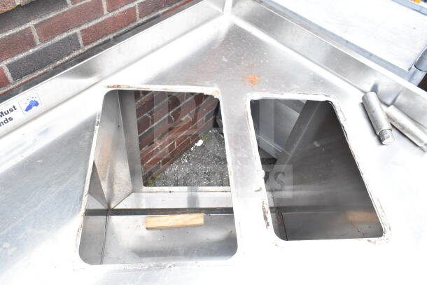 Commercial corner work station with two cutouts, three doors, stainless steel, some rust visible, labeled "Hands Must Wash."