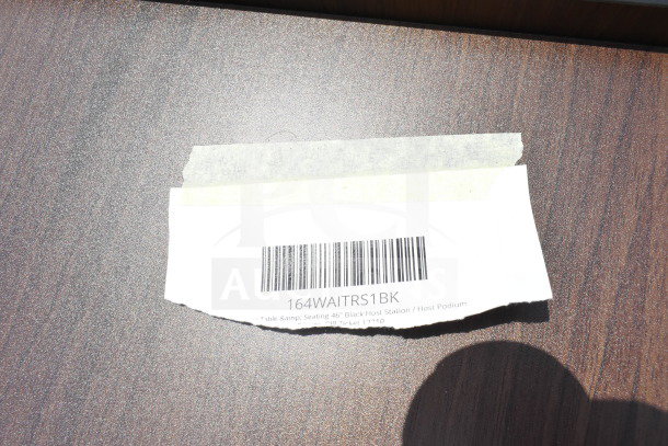 Barcoded label with text "164WAITRS1BK" indicating Lancaster Table & Seating 46" Black Host Station model.