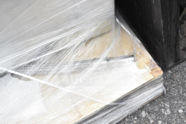 Brand new commercial 2 bay drop-in unit, visible scratches and dents, wrapped in protective plastic, ready for installation.
