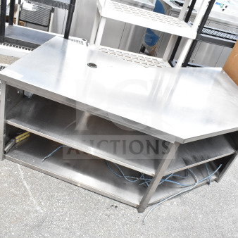 Commercial stainless steel table with two under shelves. Includes cable management hole. Slight wear visible.