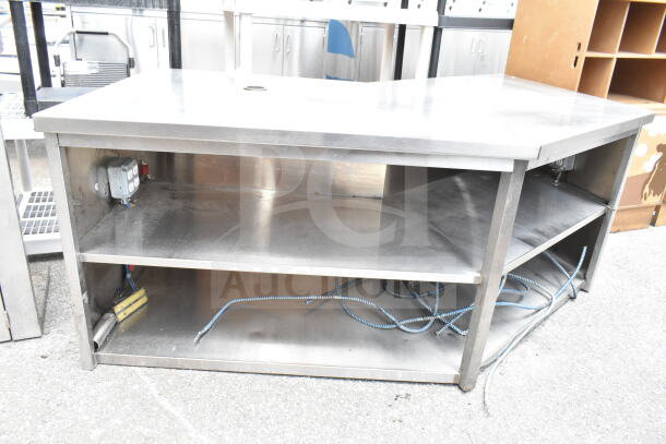 Commercial stainless steel table with two under shelves, featuring electrical outlets. Suitable for industrial use.
