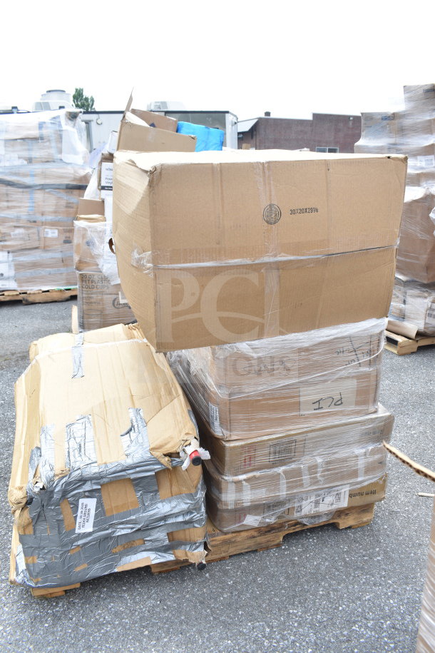 Pallet of brand new scratch and dent items, including tables and a knockdown hood, wrapped in plastic and tape, showing visible wear.