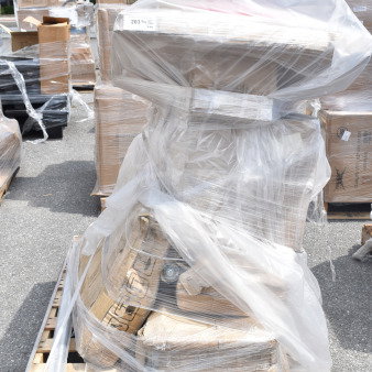 Pallet with 9 scratch and dent items including solid wood tabletop and trash can lids, wrapped in plastic and cardboard.