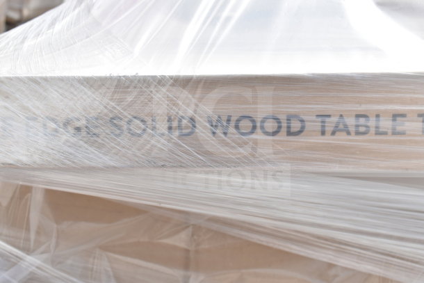 9 brand new scratch and dent items in plastic wrap, including solid wood tabletop. Text reads "SOLID WOOD TABLE."