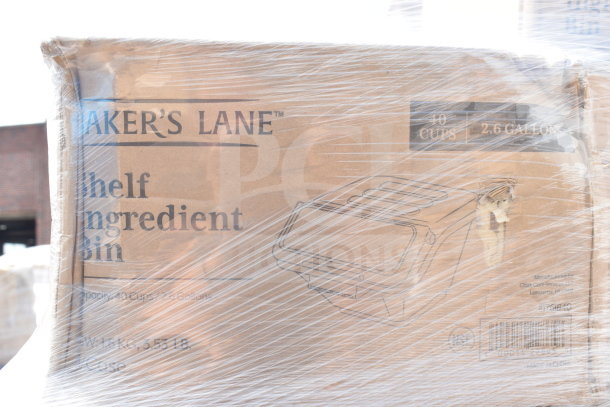 Shrink-wrapped box labeled "Baker's Lane Shelf Ingredient Bin", 40 cups/2.6 gallons. Includes steam table pan, sediment tray, wire shelf. Brand new with some scratches and dents.