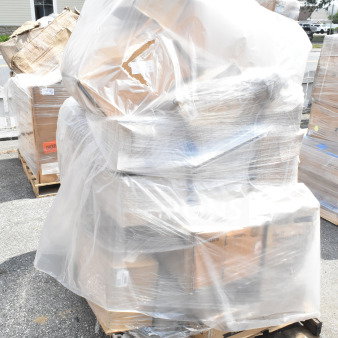 Plastic-wrapped pallet with various boxed items, including trays, sake cup, and shelves. Scratch and dent condition, 34 items.