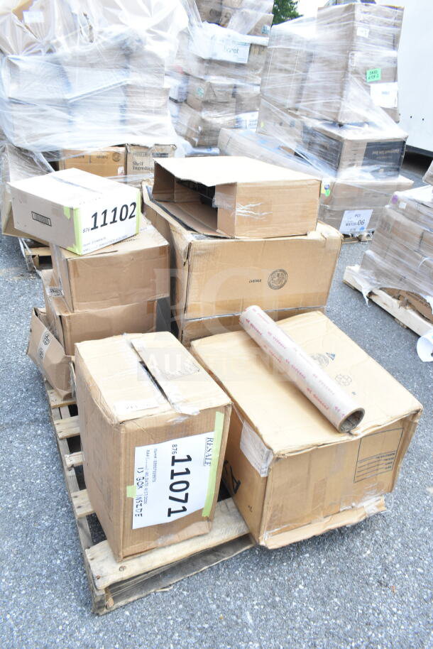 Pile of boxes on a pallet, labeled "11102" and "SIB Board," containing new scratch and dent items, including pizza pans.