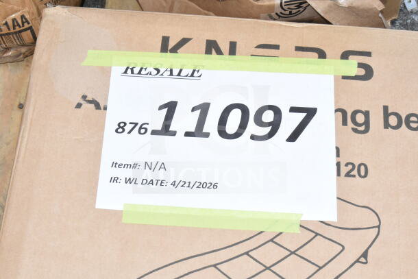 Box labeled "Resale" with number 11097 and item details for auction. Contains new scratch and dent pizza pans, SIB board.