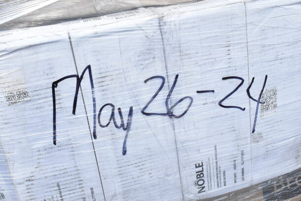 Pallet wrapped with clear plastic, labeled "May 26-24." Contains boxes of Noble items, portion bags, paper bags, gloves, 25 items.