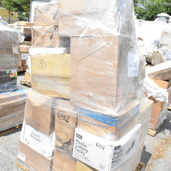 Shrink-wrapped pallet of assorted new scratch-and-dent items, including straws, hot cups, gloves, and containers.