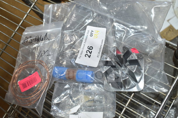 Four brand new items including Beverage-Air cap tube and Garde 8-wedge pusher in sealed bags, labelled with product codes.