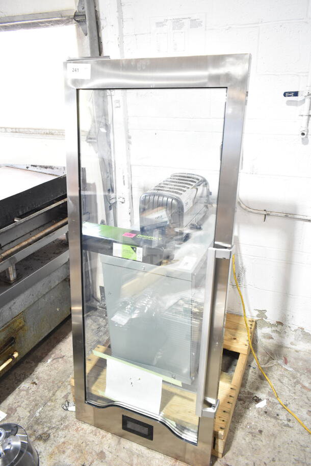 Brand new Estella 34815444 glass door for MCC220, scratch and dent, with stainless steel frame, standing on a pallet.