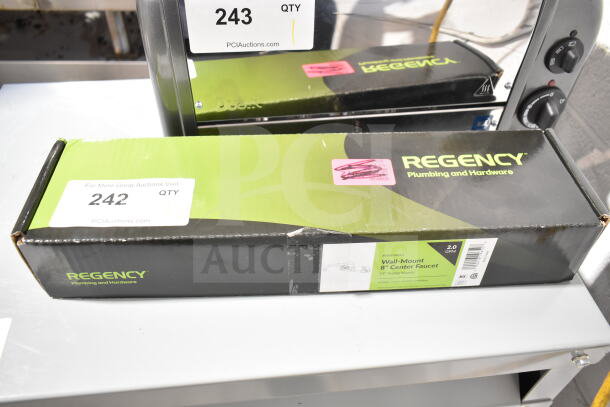 Box of BRAND NEW Regency Wall Mount Faucet with 8" centers and 14" swing spout. Label shows model 600FW814, 2.0 GPM.