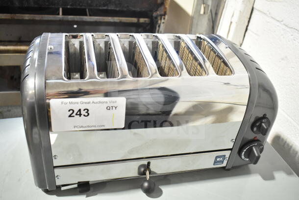 Brand new Cadco CTW-6M(220) toaster, 6-slice, 1" slots, 220 volts, minor scratches, NSF certified, auction label visible.