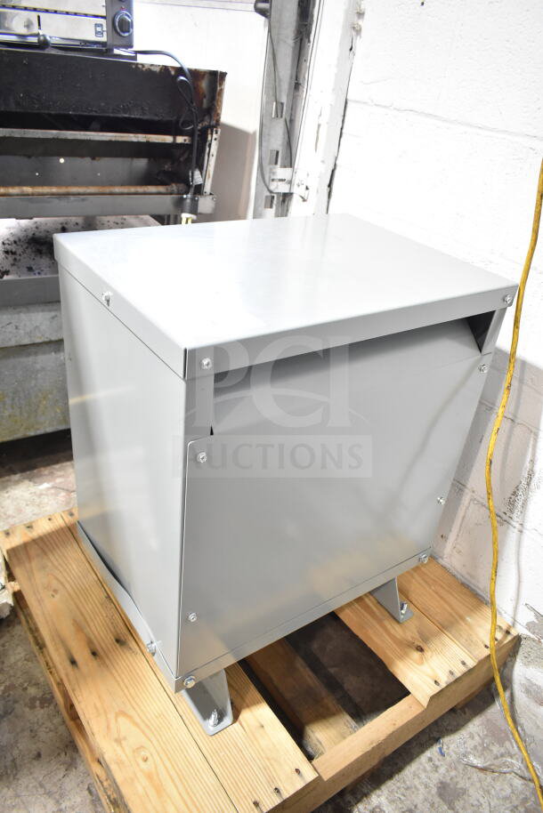 BRAND NEW Emerson EE5H45S Heavy Duty Transformer, scratch and dent, grey metal casing, on wood pallet.