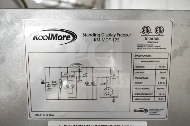KoolMore KM-MDF-17S commercial freezer tag showing model details, voltage, and refrigerant type. Made in China.