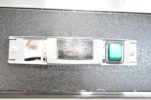 Control panel of Migali C-3F 3 Door Freezer, featuring a digital display, settings buttons, and a green power indicator.