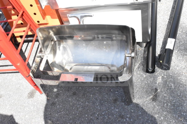 Brand new roll top chafer with minor scratches and dents, stainless steel finish, open lid, sturdy legs.