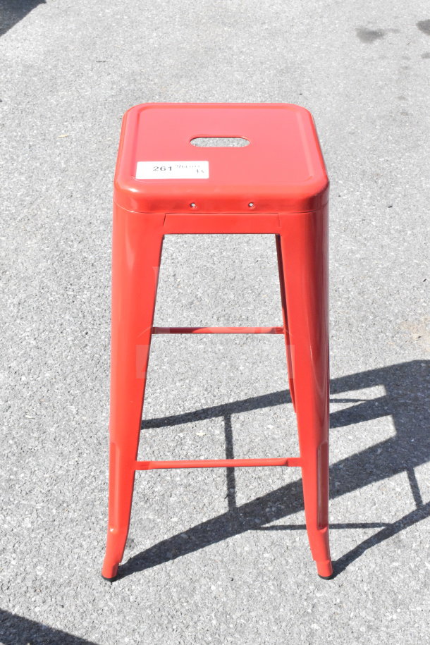 Red Tolix style bar stool, scratch and dent condition, metal construction, visible label "261," auction item.